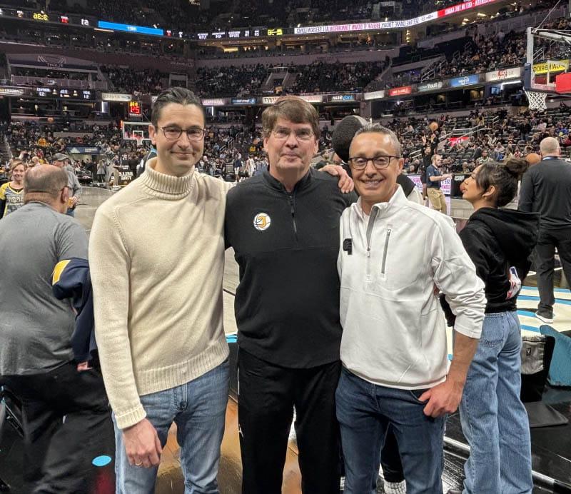 Walt Morris (center) at an NBA game with the doctors who saved his life. Dr. Felix Alva-Valdes (left) discovered Walt's aortic dissection and Dr. Giorgio Zanotti performed the 11-hour surgery. (Photo courtesy of Walt Morris)